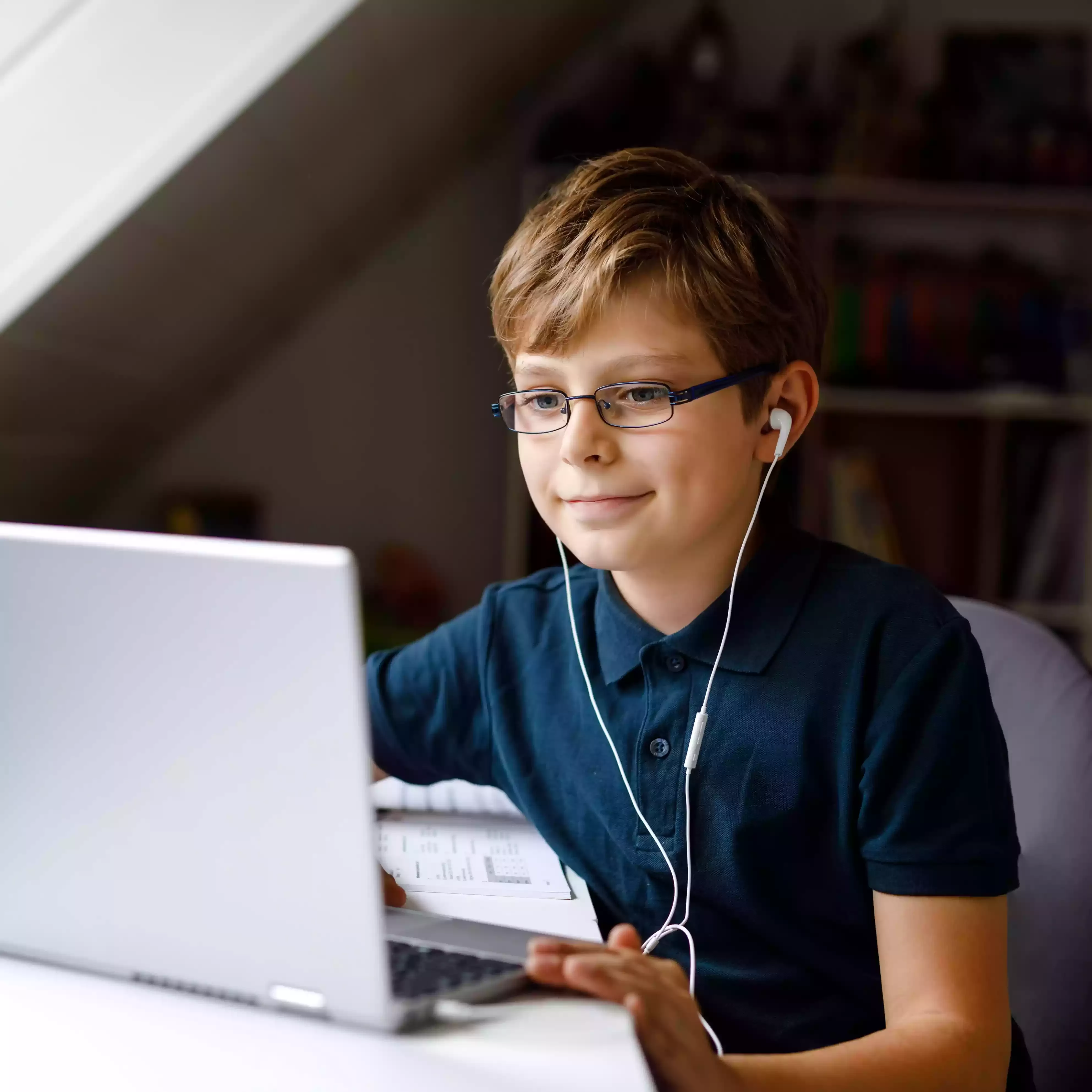 Boy with headphones looking at laptop