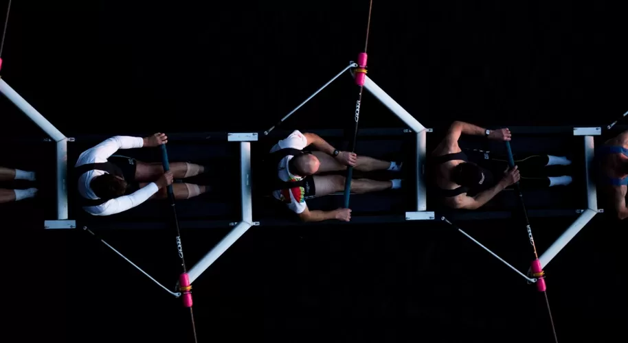 Birdseye view of dark light image of people rowing