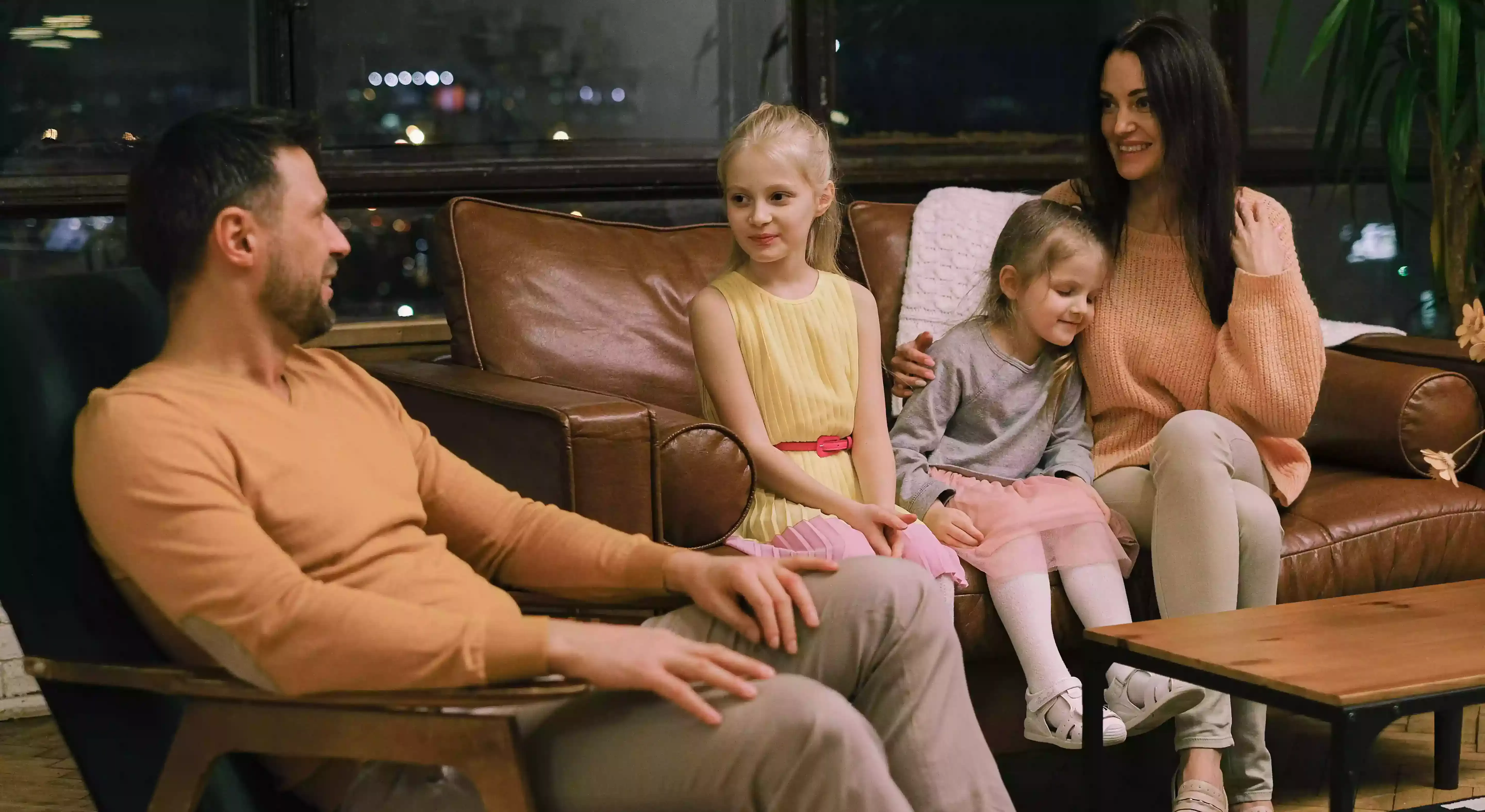 Family sitting in a couch talking