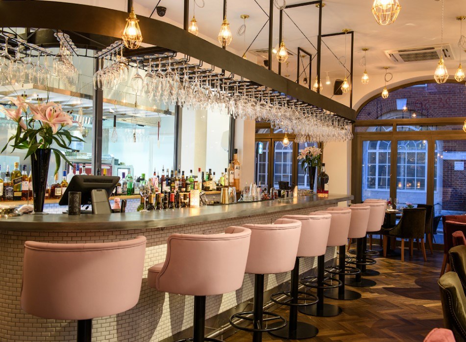 Luxury bar interior with pink bar stools