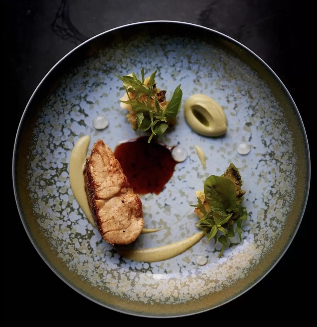 Elegant garnished Normandy inspired fine dining dish served in a bowl at restaurant Restaurant David Toutain, Paris