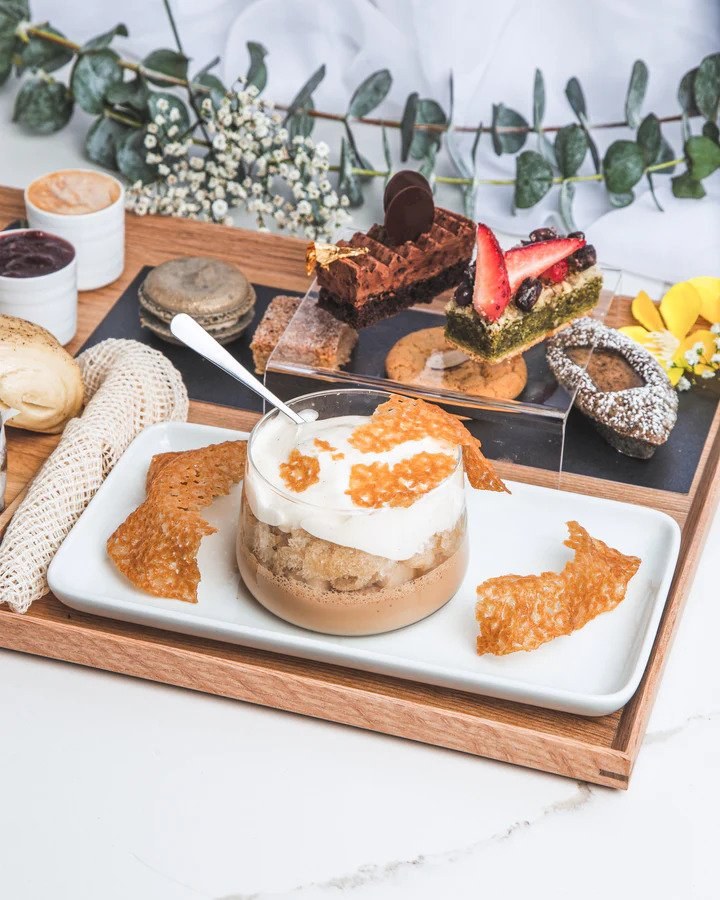 Afternoon tea served in wooden tray at Kitsby