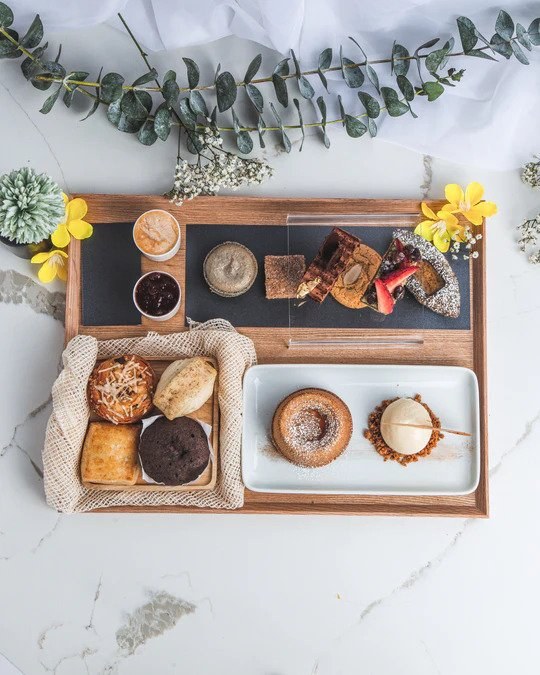Afternoon tea served in wooden tray at Kitsby