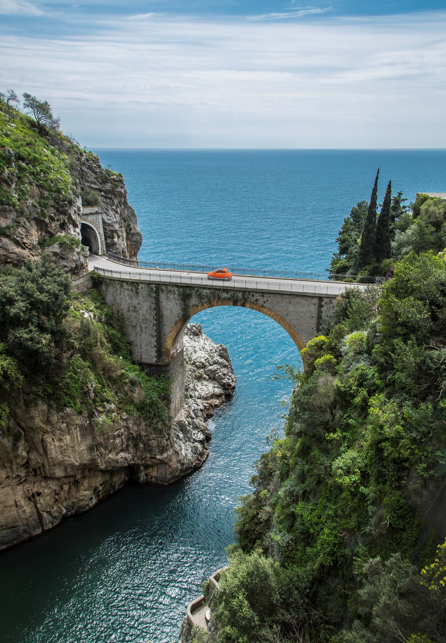 Bridge standing between two large hills over the Amalfi Coast sea