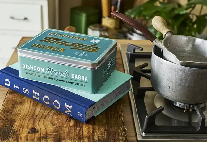 Dishoom cooking books next to a hob.