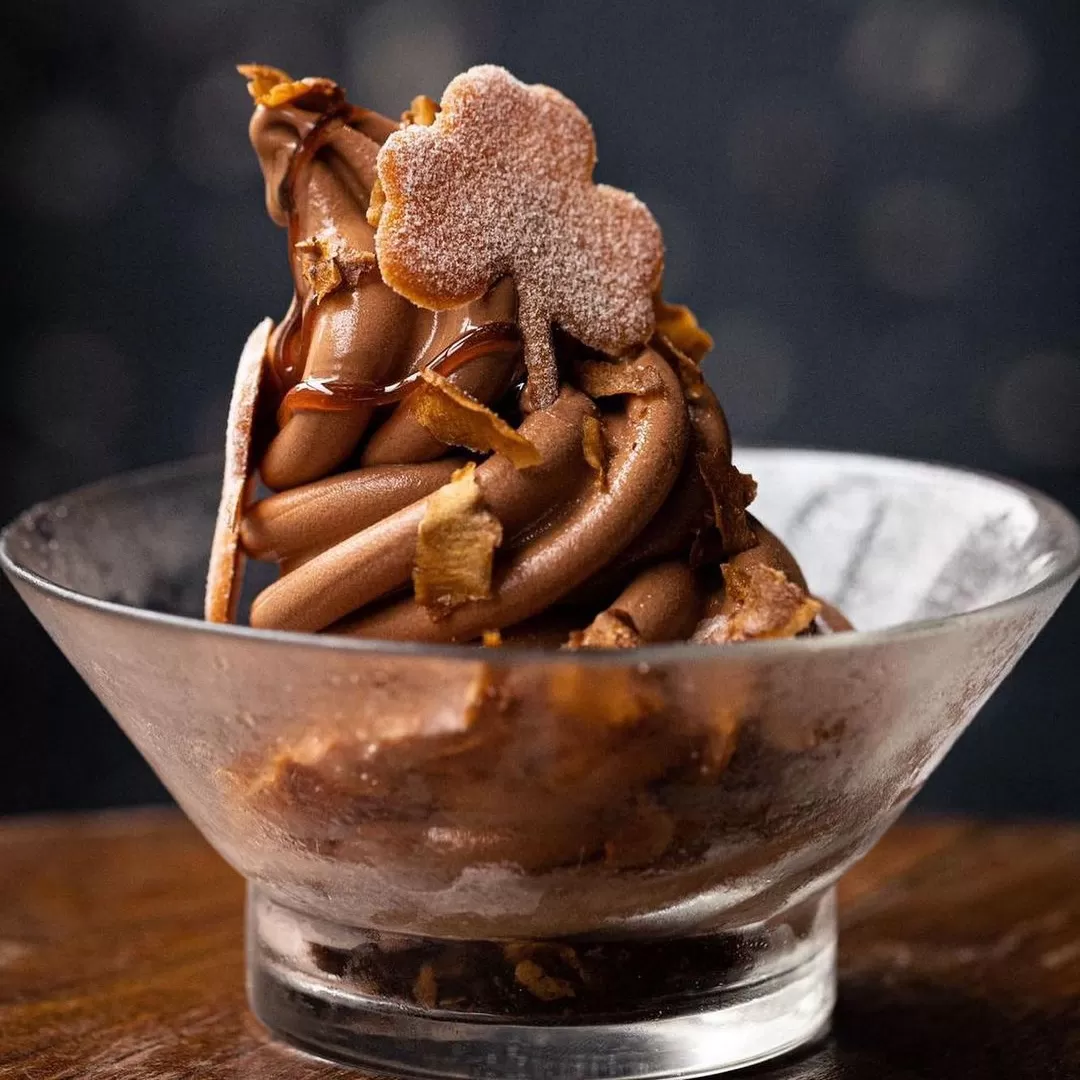 Decorative chocolate sundae pudding in a glass bowl served at Fallow, London