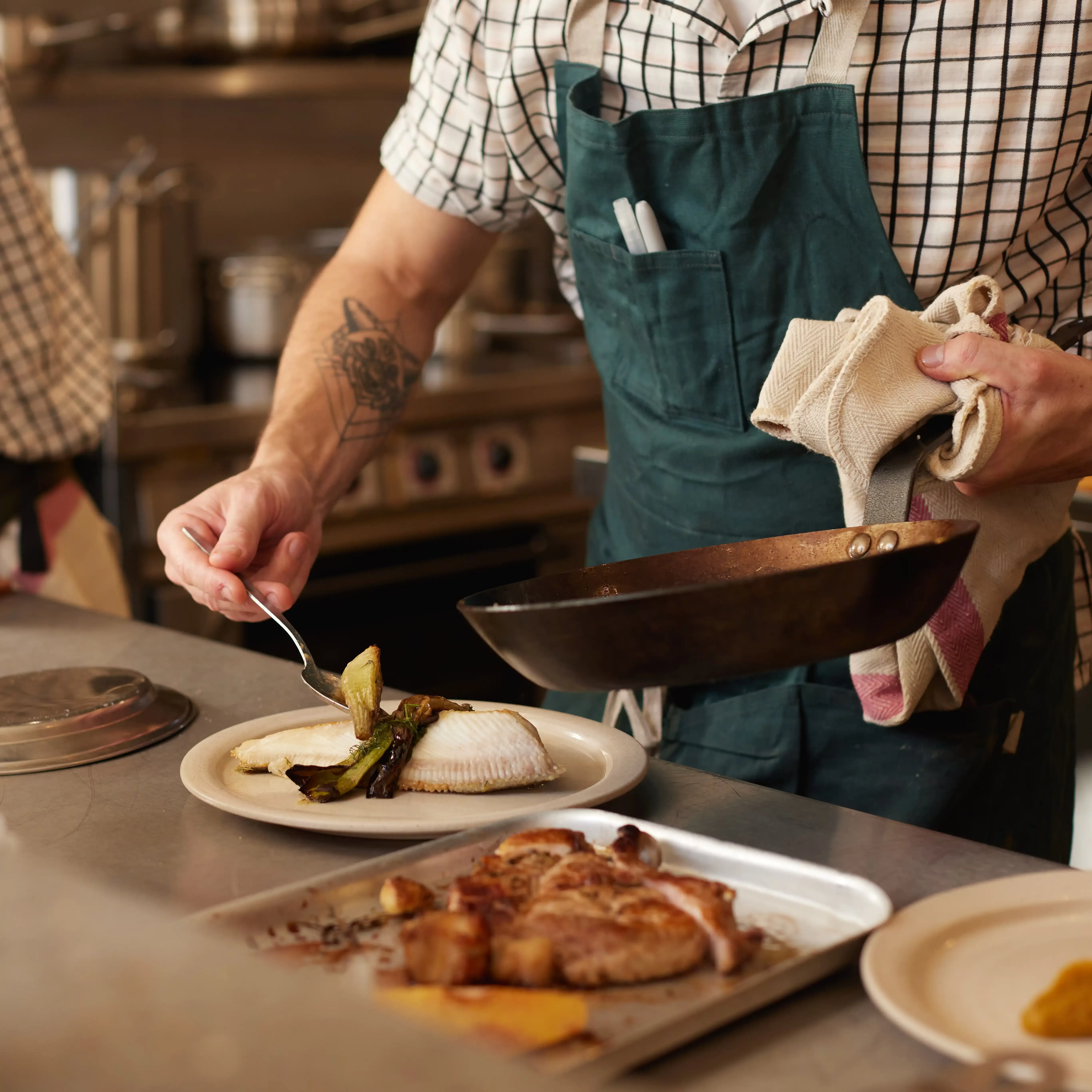 Chef in apron preparing food at Holm, South Petherton | images by Ed Reeve & Ed Schofield