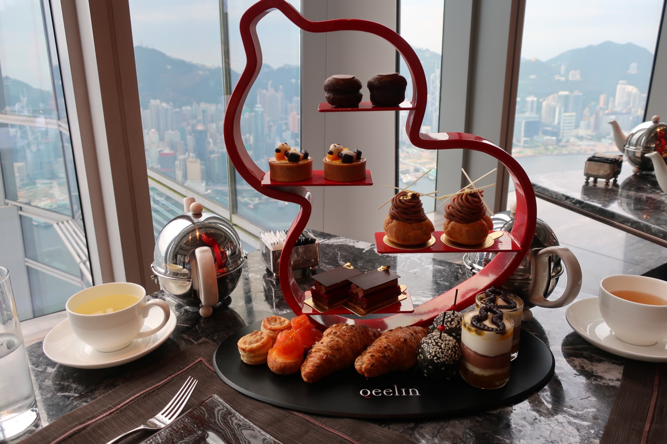 Luxury afternoon tea served on a sculpture in Hong Kong Ritz Carlton High Tea Calvin Wood with a view