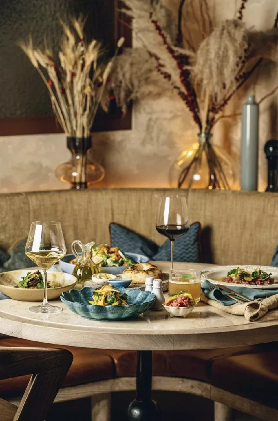 Table full of food and wine at restaurant Jeru