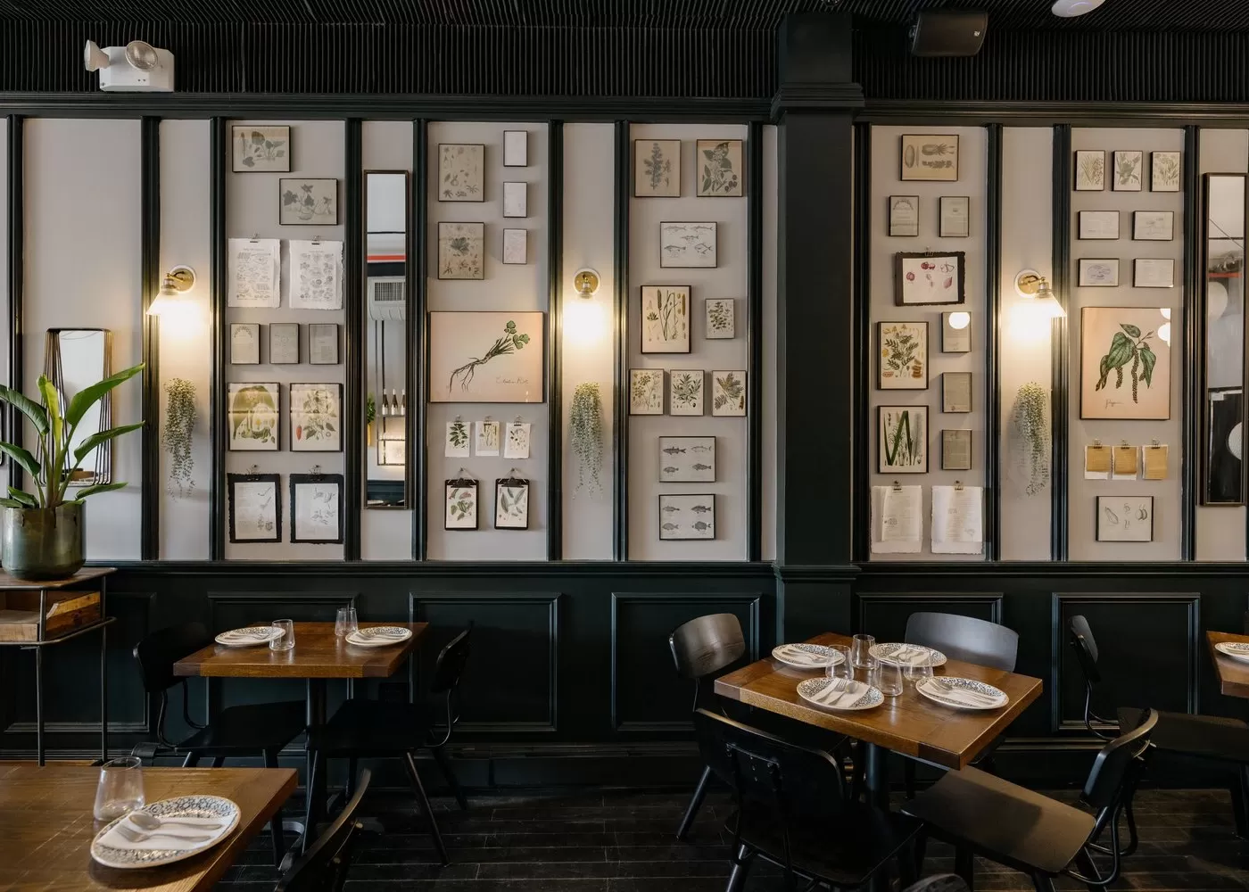 Retro chic interior with framed photos placed all over the walls at KRU, Williamsburg, USA