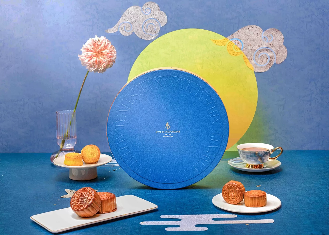 Four Seasons Hong Kong's blue hamper displays various mooncakes and, a tea cup and saucer.