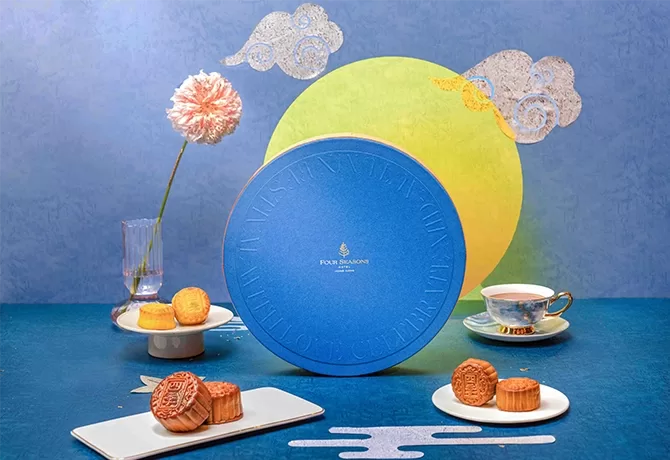Four Seasons Hong Kong's blue hamper displays various mooncakes and, a tea cup and saucer.