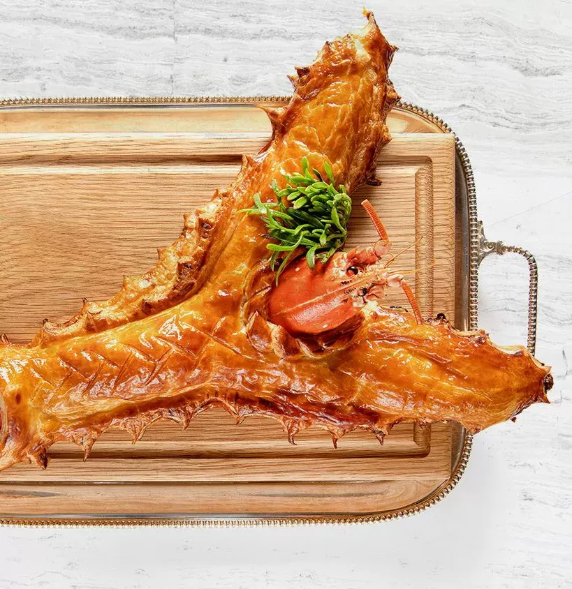 Lobster wellington served on a wooden board at Claridge’s, London