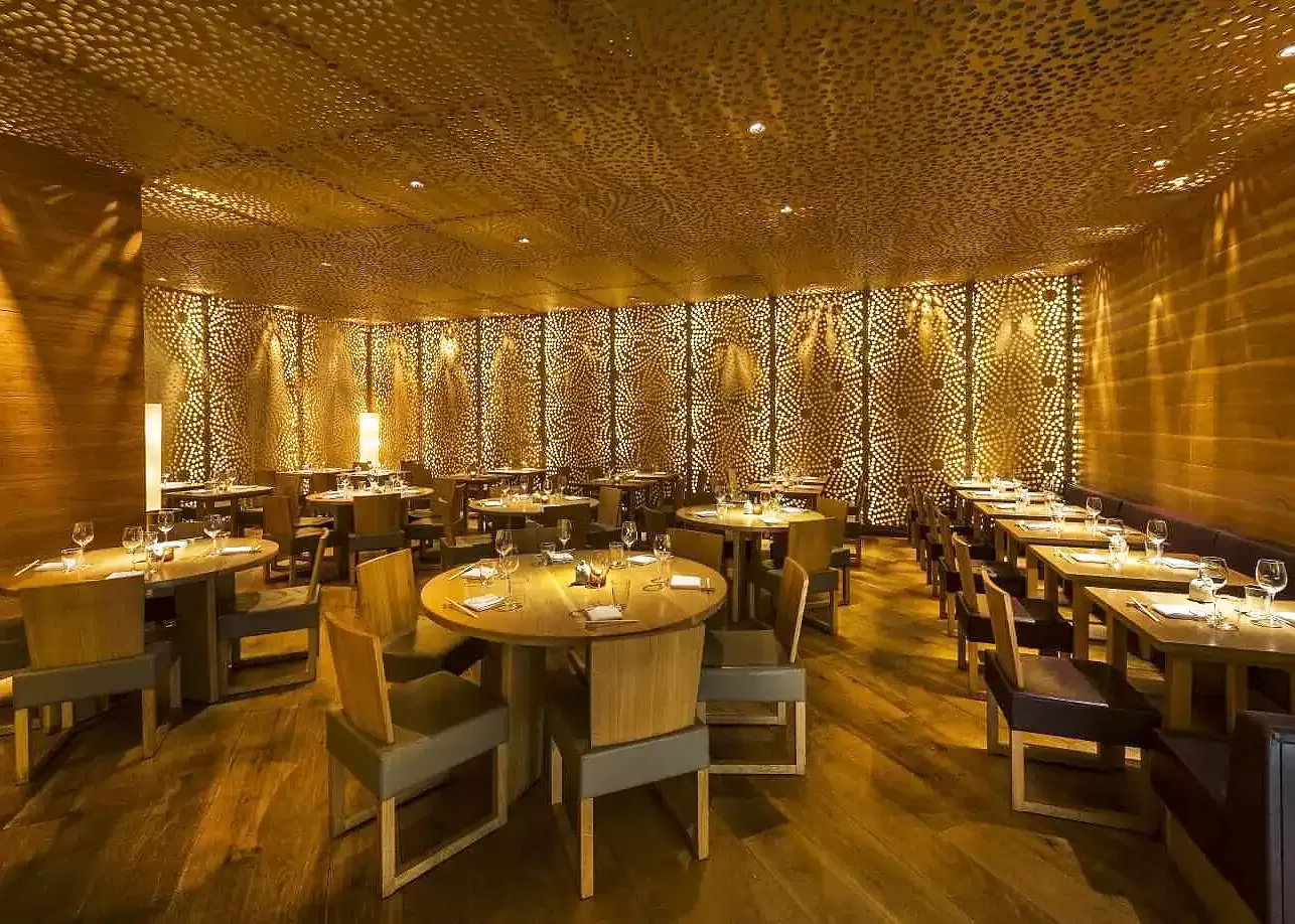 Luxury golden restaurant interior of Roka, Canary Wharf, London
