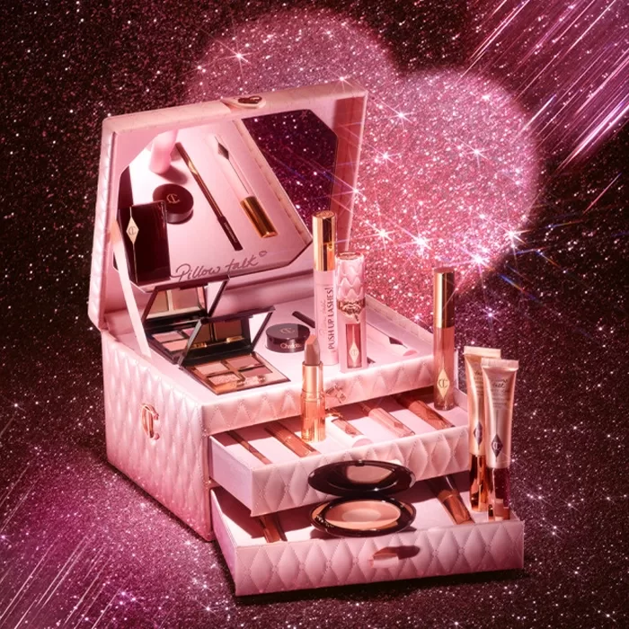Product display of Charlotte Tilbury Pillow Talk Dreams Come True, shot on a glittery pink backdrop.