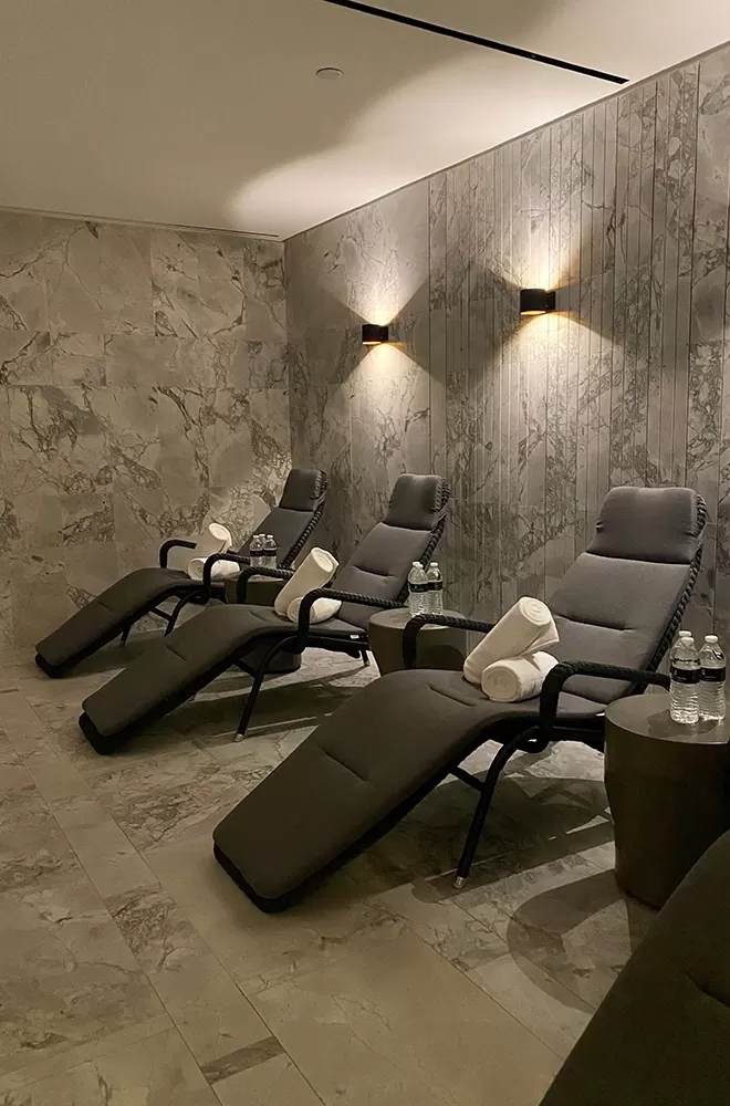 Luxury spa interior with row of comfy lounge chairs and towels at The Ritz-Carlton Spa New York, NoMad