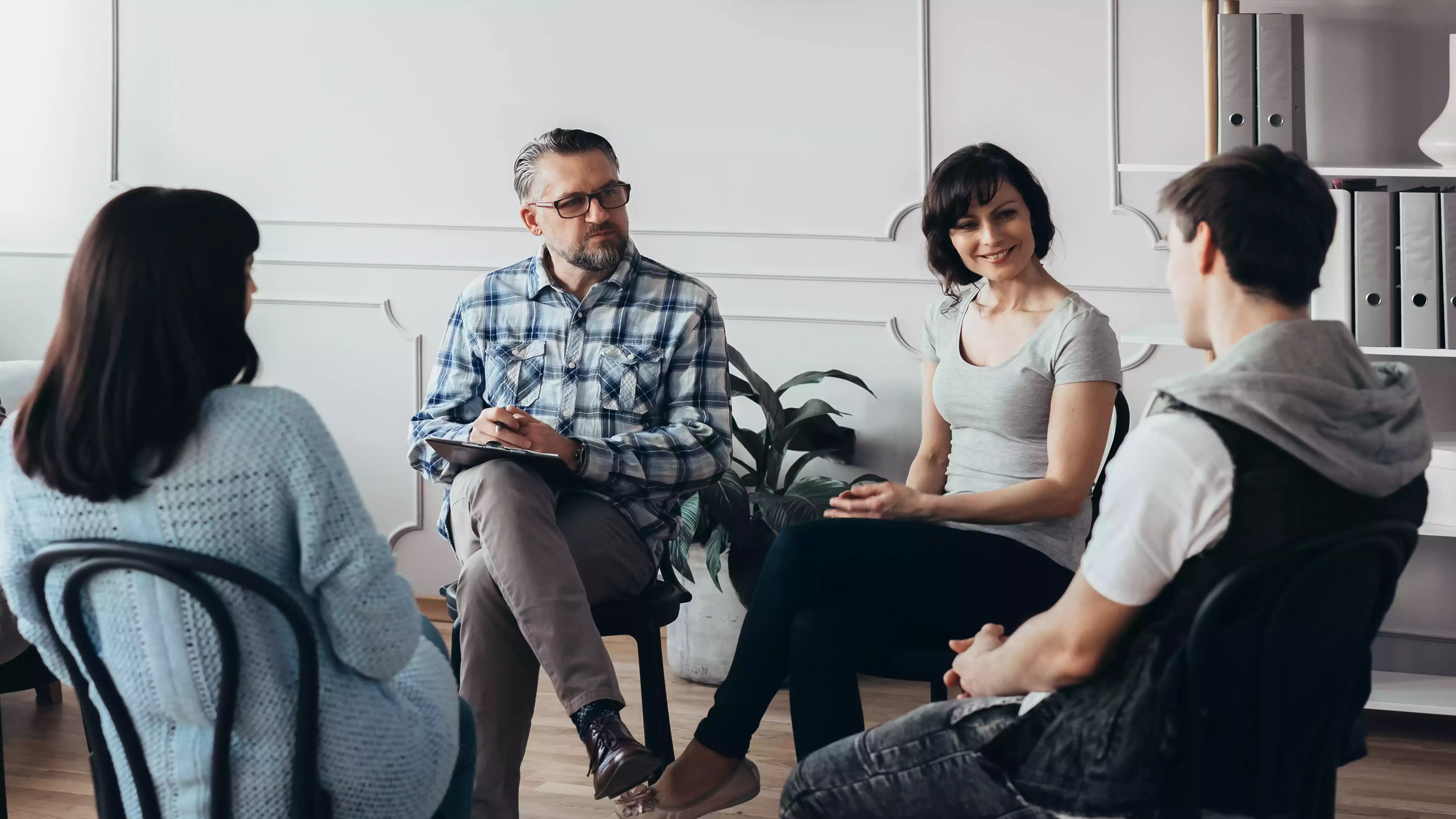 Group of people sat on chairs talking