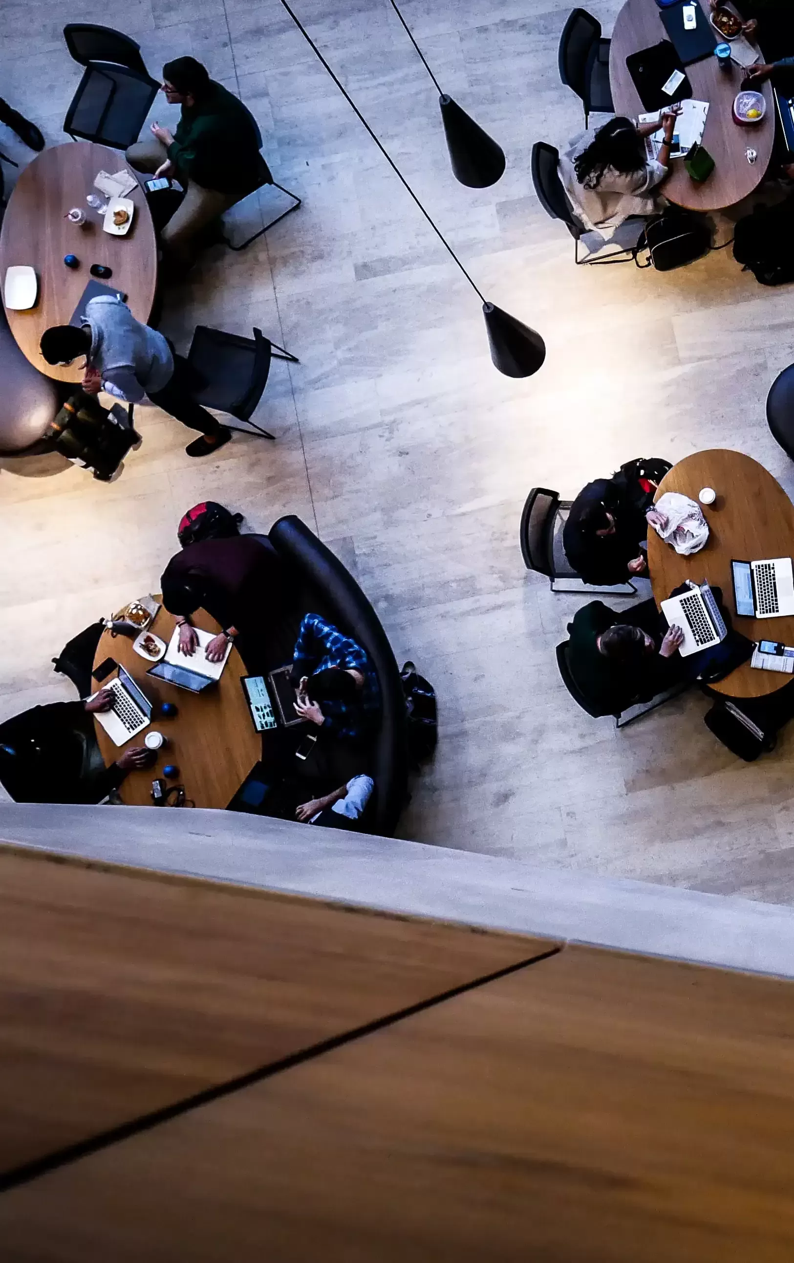 Birdseye view of people sat around tables in a library
